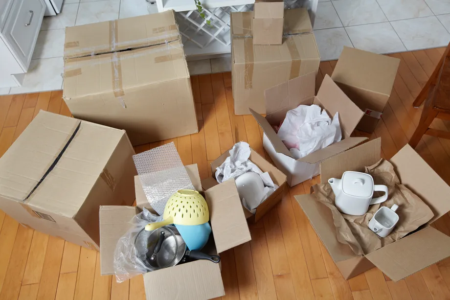 A group of moving boxes packed with dishes.