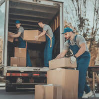 Moving Helpers Unloading A Truck